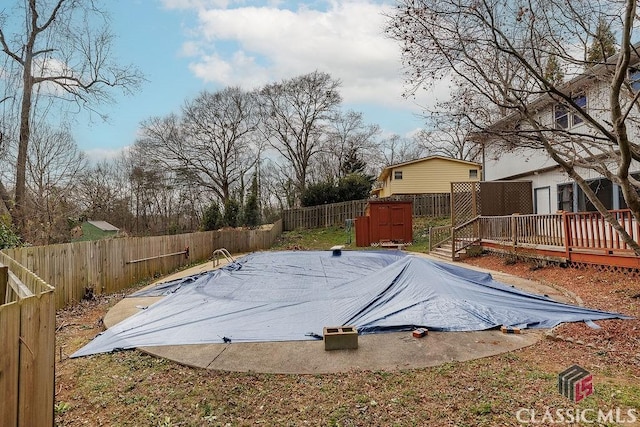 view of pool featuring a fenced in pool, a fenced backyard, and a deck