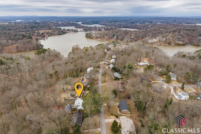 birds eye view of property with a forest view and a water view