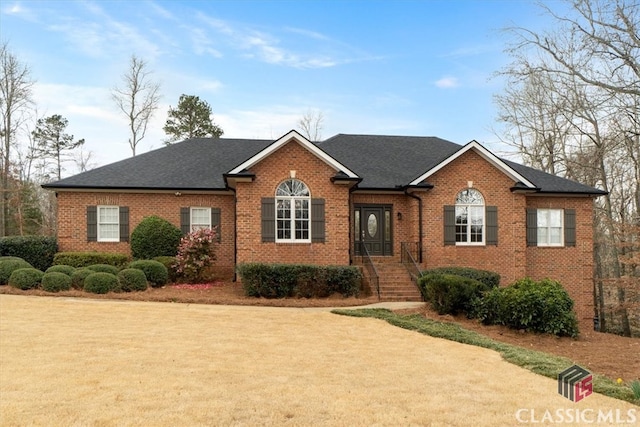 ranch-style house with brick siding and roof with shingles