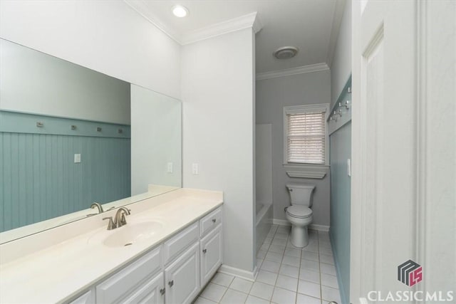 bathroom with baseboards, toilet, tile patterned flooring, crown molding, and vanity