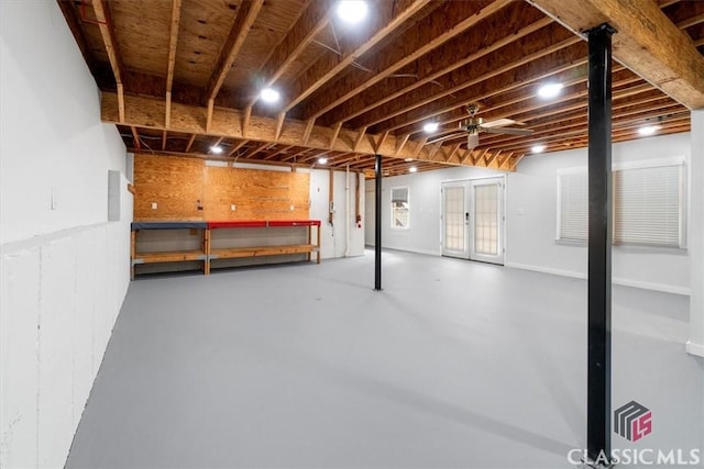 basement featuring ceiling fan and french doors