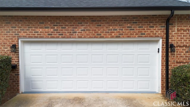 garage featuring concrete driveway