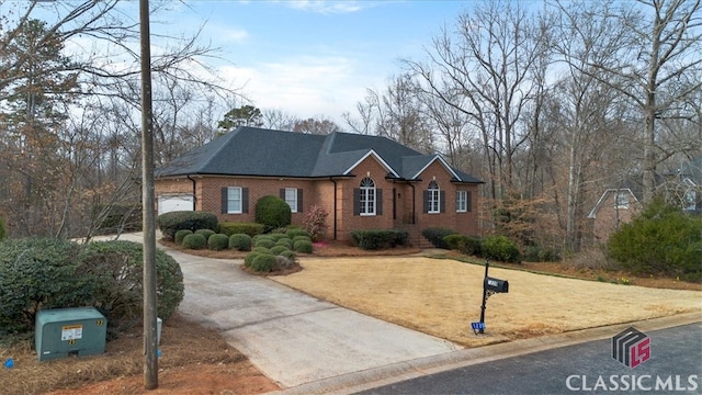 view of front of home featuring a garage, brick siding, a front lawn, and a shingled roof