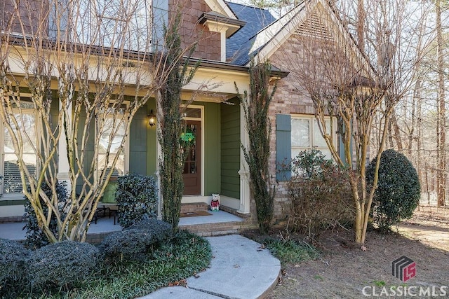 property entrance with a shingled roof