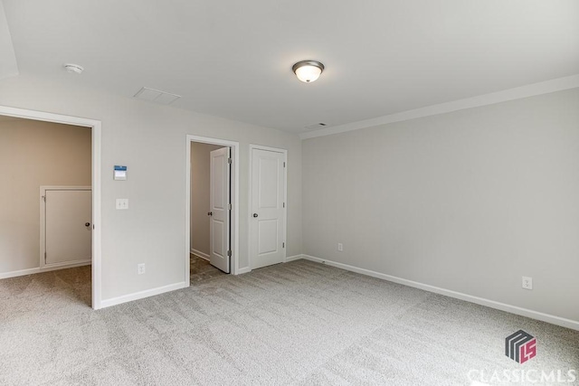 unfurnished bedroom with carpet floors and baseboards