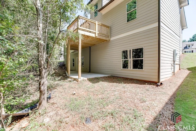 back of property with a patio area and a wooden deck