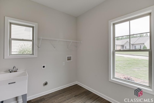 clothes washing area featuring hookup for a washing machine, a wealth of natural light, laundry area, and baseboards