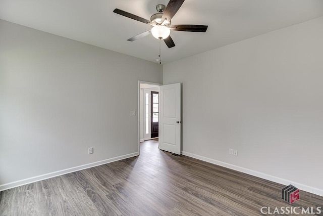 spare room with a ceiling fan, baseboards, and wood finished floors