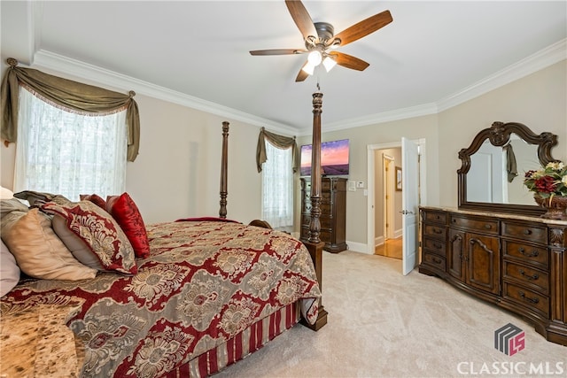 bedroom with ornamental molding, multiple windows, a ceiling fan, and light colored carpet