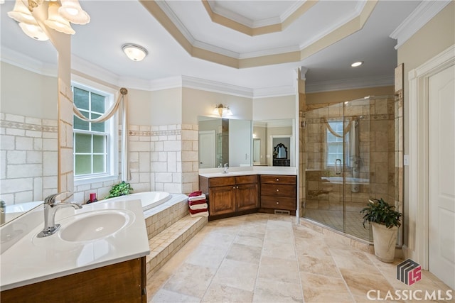 bathroom featuring ornamental molding, a stall shower, a garden tub, and vanity