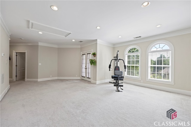 workout area with crown molding, attic access, visible vents, and light colored carpet