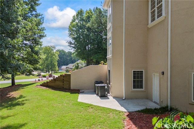 view of yard featuring central AC unit and a patio