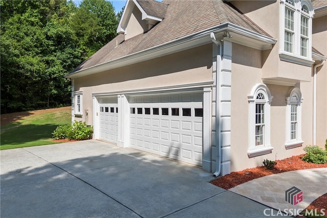 garage with concrete driveway