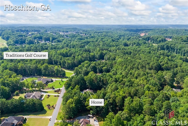 birds eye view of property with a wooded view