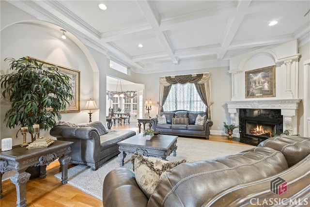 living room with coffered ceiling, beamed ceiling, a fireplace, and wood finished floors