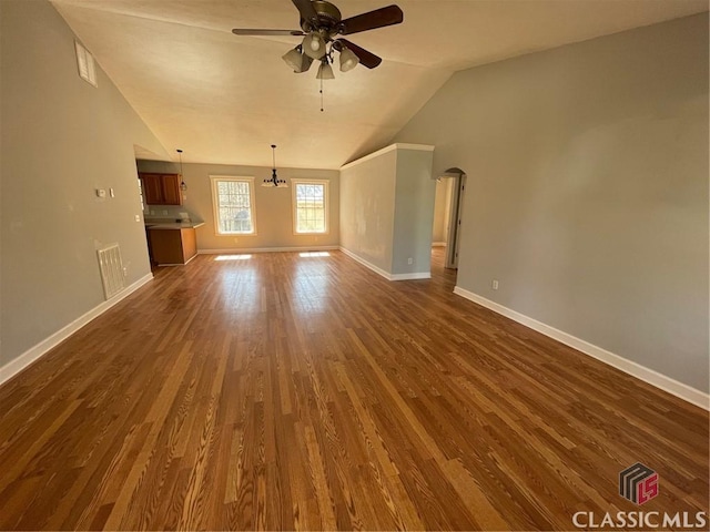 unfurnished living room featuring visible vents, dark wood-type flooring, lofted ceiling, baseboards, and ceiling fan