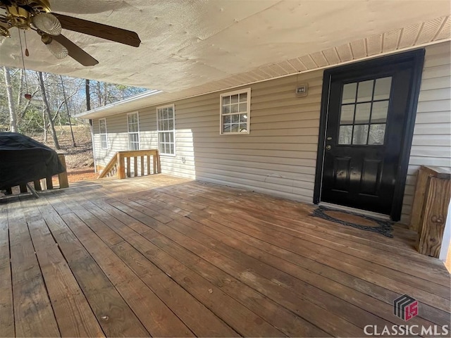 wooden deck featuring a grill and ceiling fan