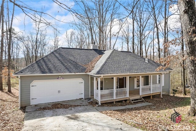 ranch-style house featuring covered porch, an attached garage, concrete driveway, and roof with shingles