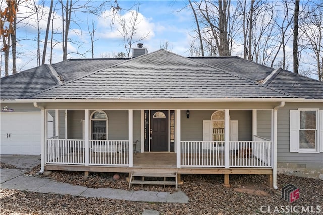 view of front facade with an attached garage, a porch, a chimney, and roof with shingles