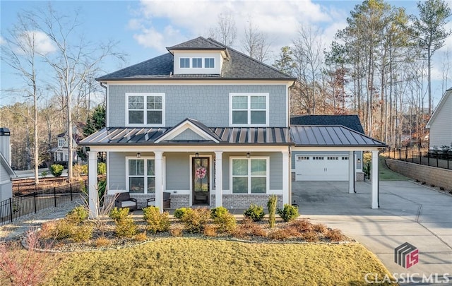 american foursquare style home with fence, driveway, a standing seam roof, a porch, and a garage