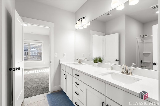 full bathroom with double vanity, visible vents, tile patterned floors, and a sink