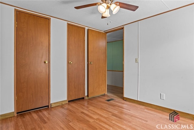 unfurnished bedroom with a ceiling fan, light wood-style floors, and visible vents