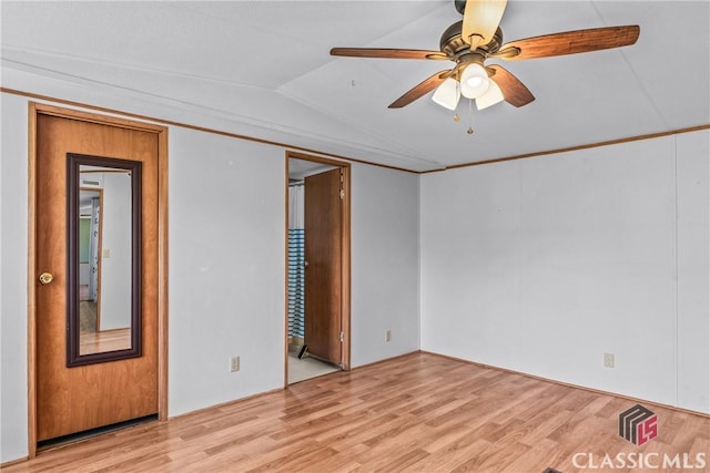 unfurnished bedroom featuring vaulted ceiling, light wood-style floors, and ceiling fan