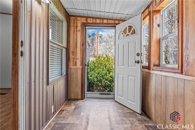 doorway featuring wood walls