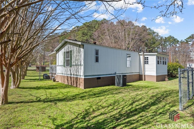 view of property exterior with crawl space, central AC, a yard, and fence