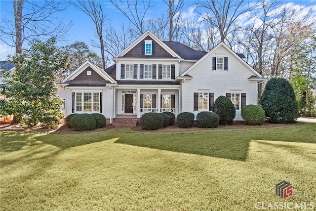 view of front of home with a porch and a front lawn