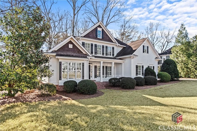 view of front of home featuring covered porch and a front yard