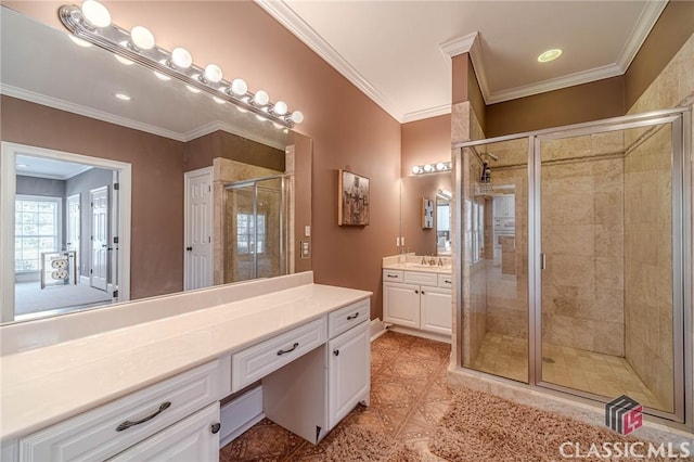 bathroom with vanity, ornamental molding, and a stall shower
