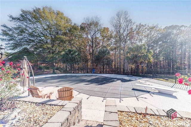 view of pool with a patio and fence