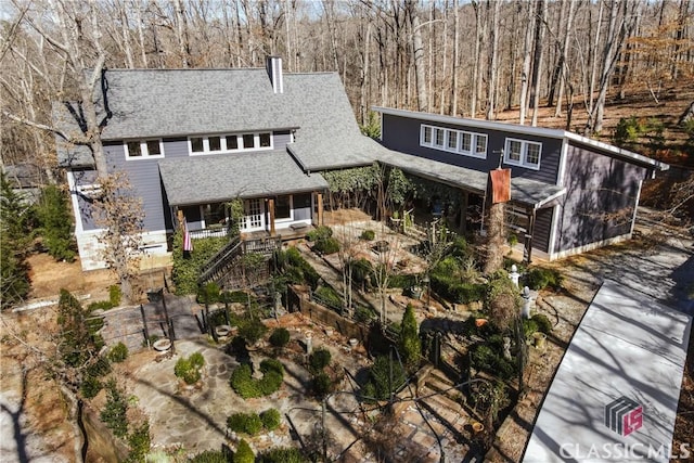 view of front of home with stairs and roof with shingles