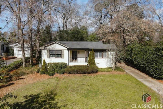 view of front of house featuring a front yard and an outdoor structure