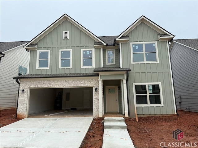329 Ridge Pointe Dr, Athens, GA 30606 - view of front of property with board and batten siding, an attached garage, driveway, and roof with shingles