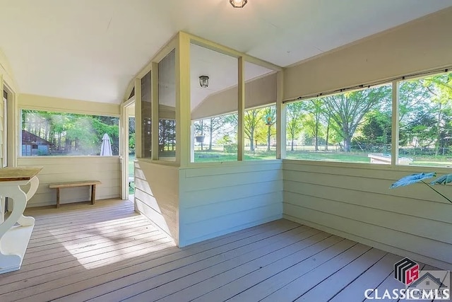 unfurnished sunroom with lofted ceiling