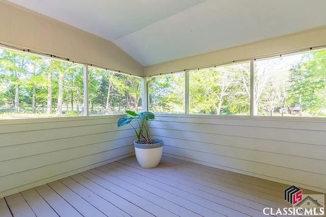 unfurnished sunroom with vaulted ceiling and a healthy amount of sunlight