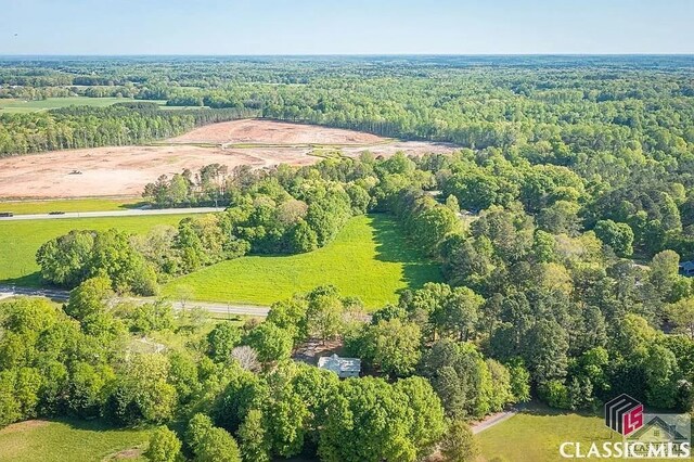 bird's eye view with a wooded view