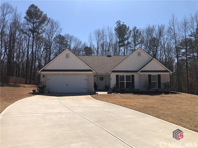 view of front facade with brick siding, an attached garage, and concrete driveway