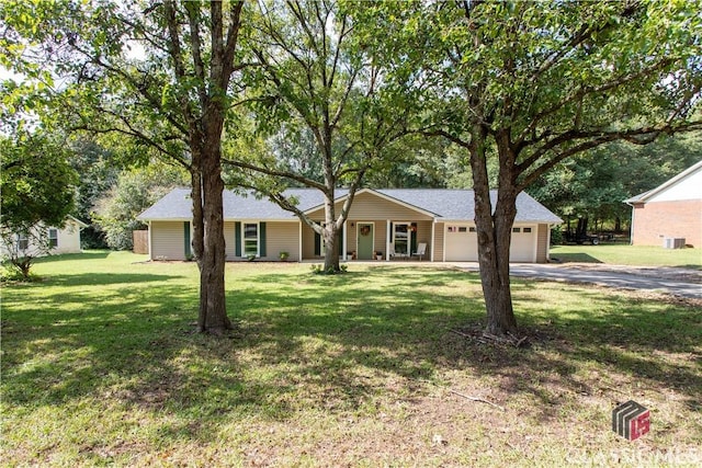 single story home featuring an attached garage, driveway, and a front lawn