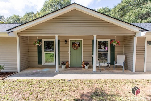 view of front of home with covered porch and a shingled roof