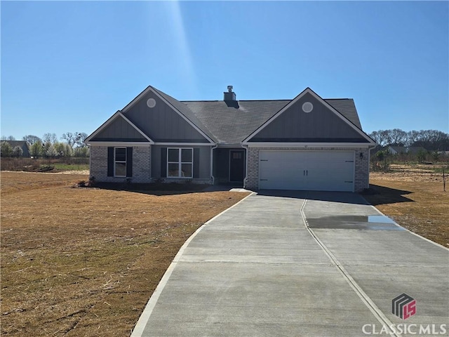 view of front of home featuring brick siding, driveway, and an attached garage