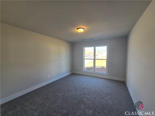 unfurnished room with baseboards, carpet floors, and a textured ceiling