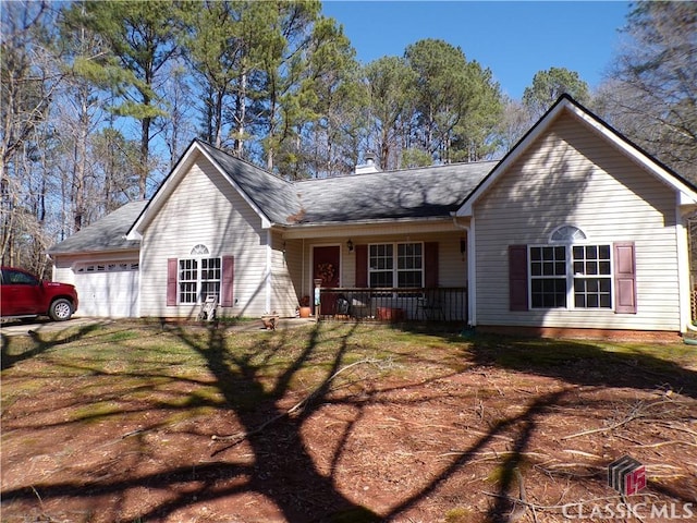 ranch-style home featuring a chimney, covered porch, and an attached garage