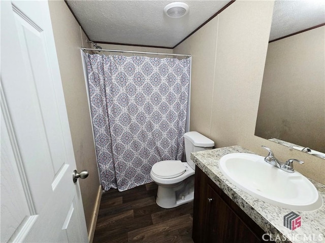 305 Langford Carey Rd, Danielsville, GA 30633 - full bathroom with wood finished floors, vanity, toilet, a textured ceiling, and a shower with curtain