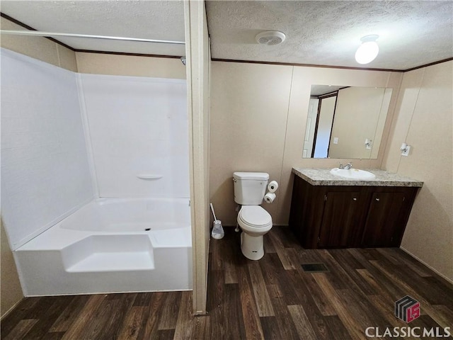 305 Langford Carey Rd, Danielsville, GA 30633 - full bathroom featuring wood finished floors, vanity, toilet, shower / tub combination, and a textured ceiling