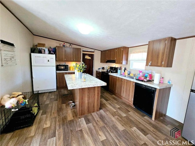 305 Langford Carey Rd, Danielsville, GA 30633 - kitchen with black appliances, dark wood-style flooring, light countertops, a textured ceiling, and lofted ceiling