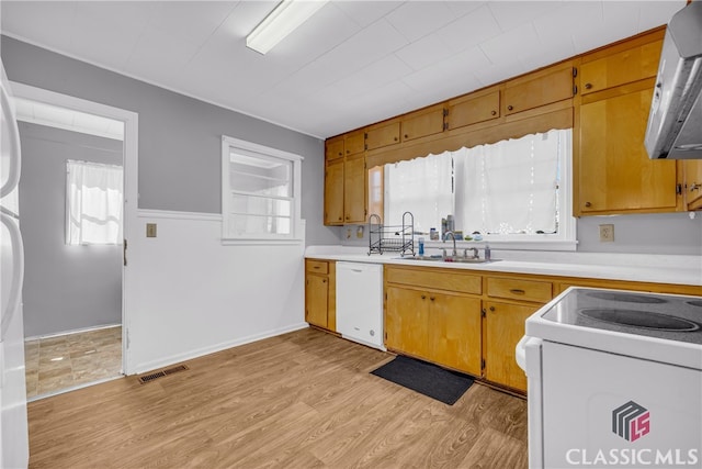 kitchen featuring light wood-style floors, white appliances, light countertops, and visible vents