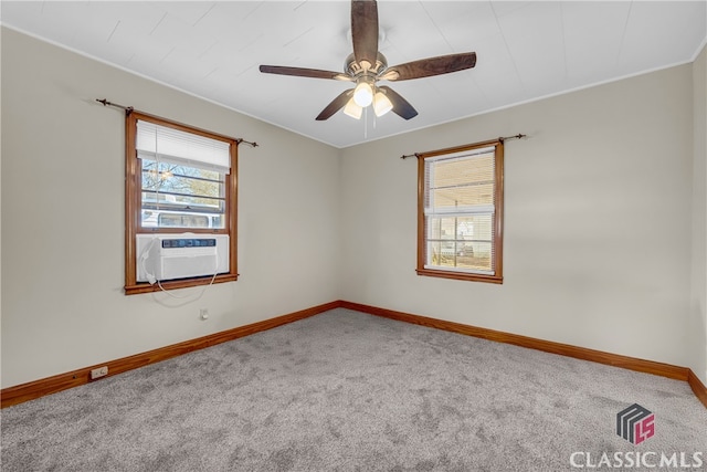 spare room featuring cooling unit, a ceiling fan, baseboards, and carpet floors